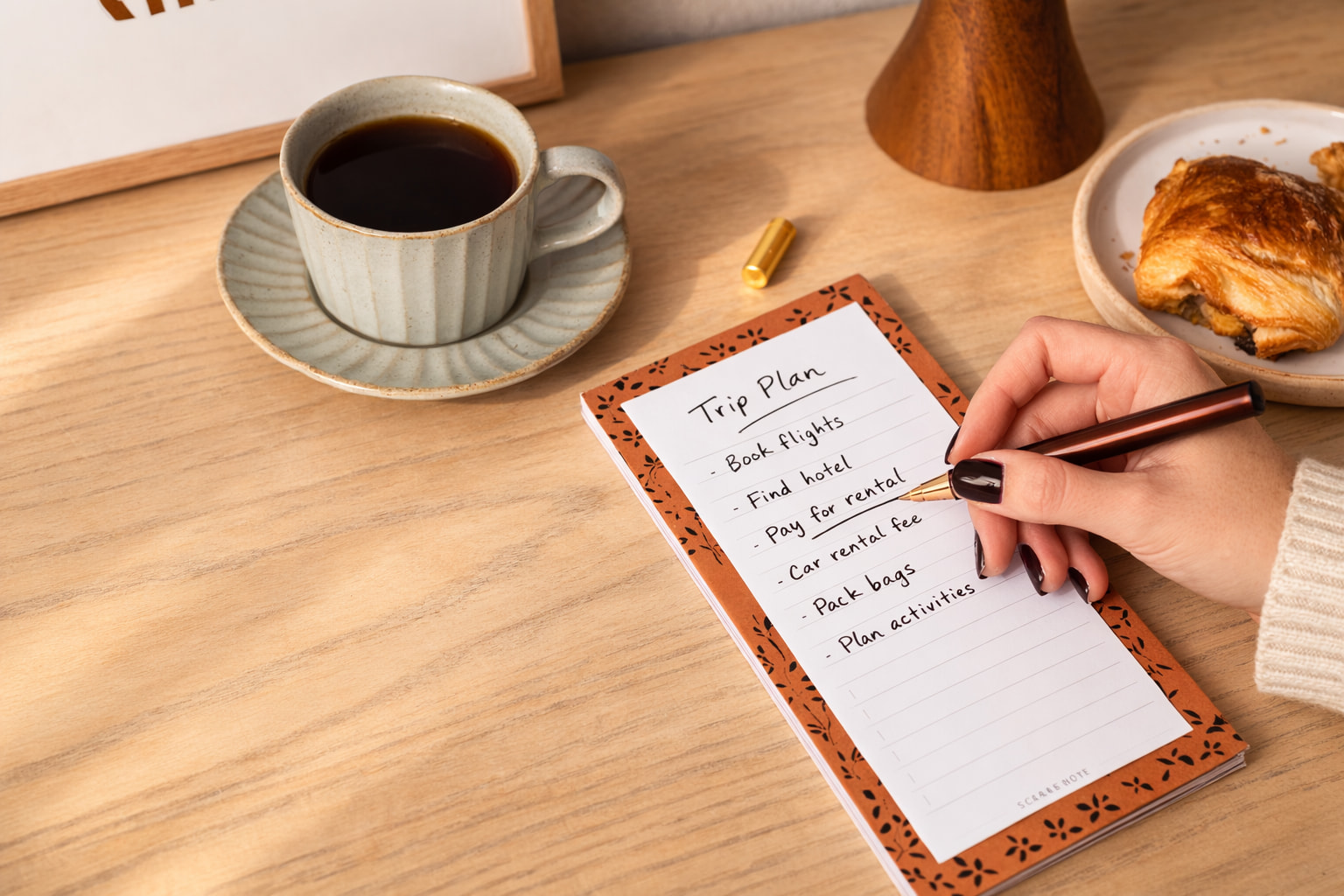 Notebook with clear line items and a cup of coffee